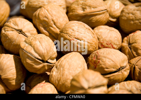Horizontal close up of walnuts in their shells. Stock Photo