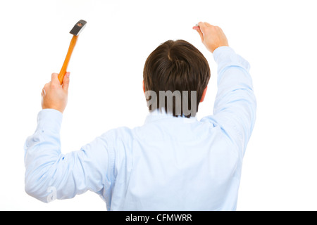 Construction worker hammering nail. Back view Stock Photo