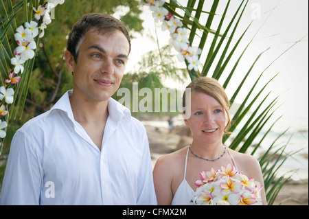 Weddings at the dream beaches on The Seychelles are romantic and common. This German couple enjoys their ceremony on Prasline. Stock Photo