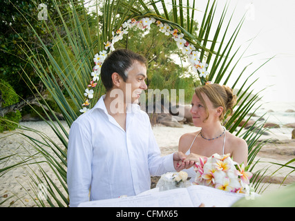 Weddings at the dream beaches on The Seychelles are romantic and common. This German couple enjoys their ceremony on Prasline. Stock Photo