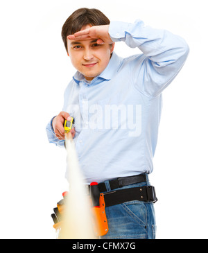 Construction worker looking into the distance on ruler Stock Photo