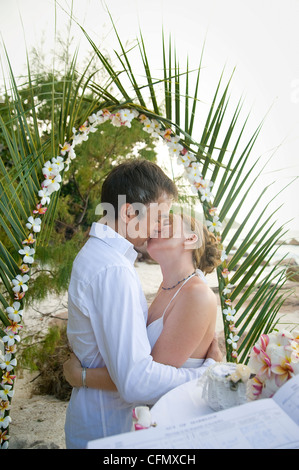 Weddings at the dream beaches on The Seychelles are romantic and common. This German couple enjoys their ceremony on Prasline. Stock Photo