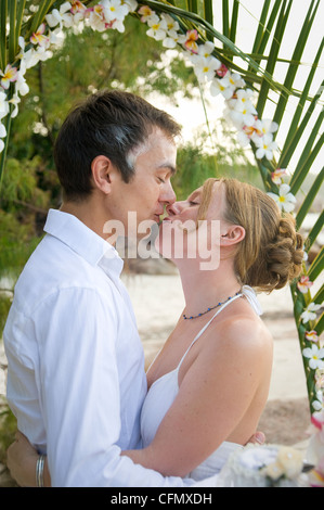 Weddings at the dream beaches on The Seychelles are romantic and common. This German couple enjoys their ceremony on Prasline. Stock Photo