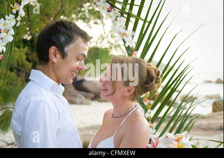 Weddings at the dream beaches on The Seychelles are romantic and common. This German couple enjoys their ceremony on Prasline. Stock Photo