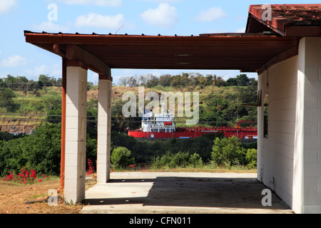 Ship On The Panama Canal Framed In The Car Port Of A Bungalow From The Former Fort Clayton, Panama Stock Photo