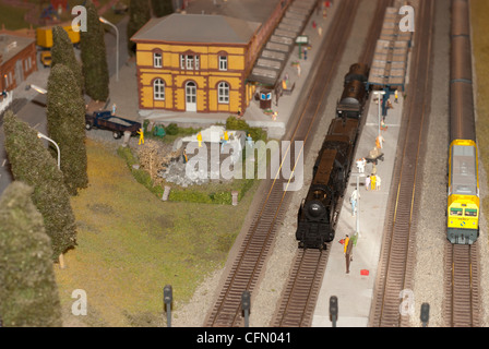 two models of a miniature trains in a train station Stock Photo