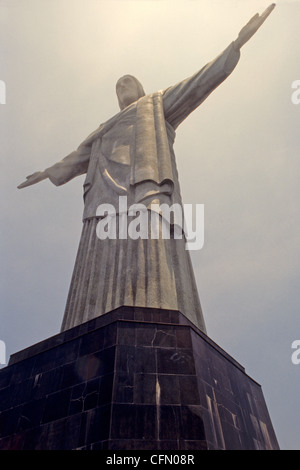 Christ the Redeemer statue of Jesus Christ rises above Rio de Janeiro Brazil atop Corcovado mountain Stock Photo