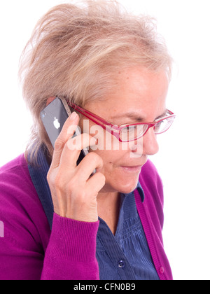 Close up of mature woman with red glasses talking on iPhone Stock Photo