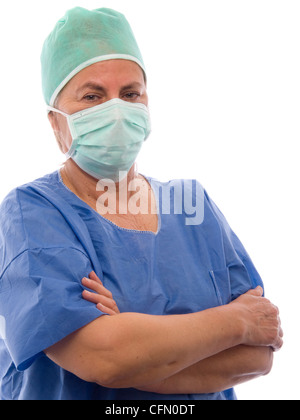 Portrait of female middle aged doctor wearing surgical face mask with arms crossed isolated on white background Stock Photo