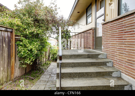 Simple brick rambler house exterior side. Stock Photo