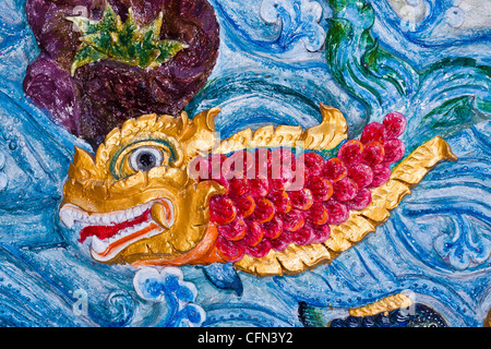 Native art carved on the wall in the temple. Stock Photo