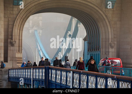 Commuters crossing Tower Bridge in the morning, London Stock Photo