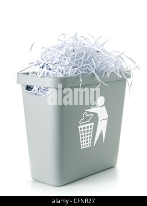 Paper cuttings in gray plastic disposal bin with white paper trash symbol - over white background Stock Photo