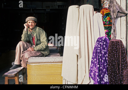 Portrait of a tailor from Gilgit in front of his shop tailoring, Hunza Valley, Pakistan. Stock Photo