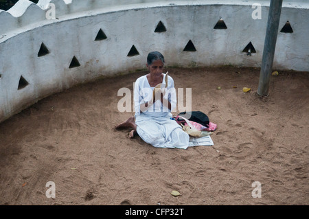 praying for luck at the Natha Devale shrine in Kandy, Sri Lanka Stock Photo