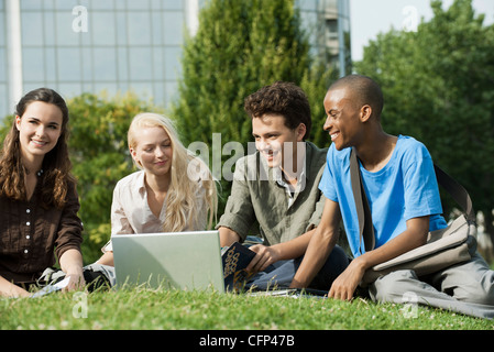 University students studying together on grass Stock Photo