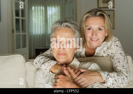 Mother and daughter spending time in living room Stock Photo