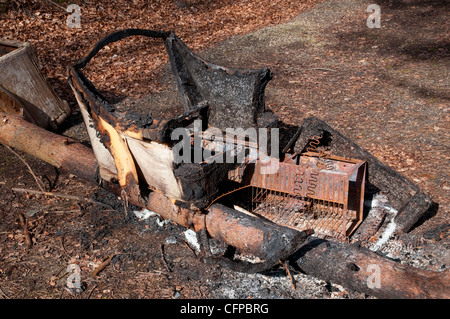 Fire damaged chair in burnt out common room in abandoned mental asylum ...