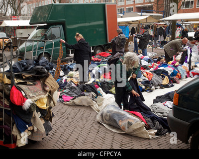 People looking at used clothes on the Waterlooplein square market in Amsterdam, the Netherlands Stock Photo