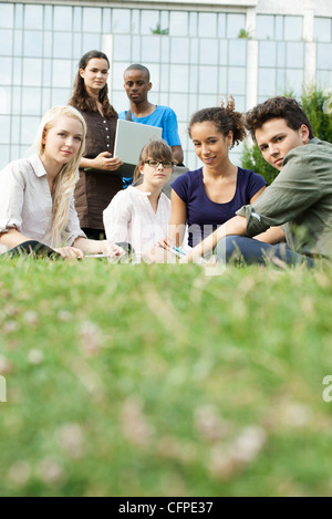 Young people hanging out on grass Stock Photo