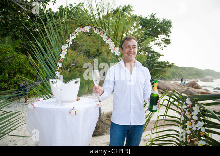 Weddings at the dream beaches on The Seychelles are romantic and common. This German couple enjoys their ceremony on Prasline. Stock Photo