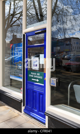 Large button for disabled people to press to gain wheelchair access to UK shop or bank Stock Photo