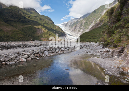 Franz Josef Glacier, West Coast, New Zealand, reflected in a stream in the valley. Stock Photo