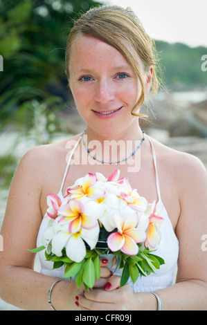 Weddings at the dream beaches on The Seychelles are romantic and common. This German couple enjoys their ceremony on Prasline. Stock Photo