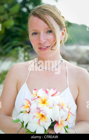 Weddings at the dream beaches on The Seychelles are romantic and common. This German couple enjoys their ceremony on Prasline. Stock Photo