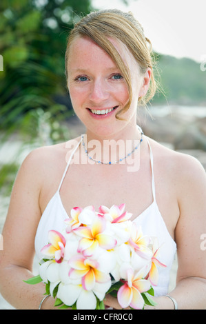 Weddings at the dream beaches on The Seychelles are romantic and common. This German couple enjoys their ceremony on Prasline. Stock Photo