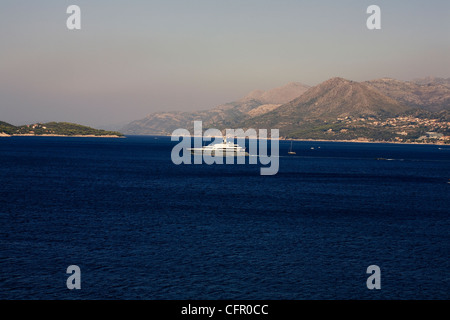 Motor yacht sailing out of Dubrovnik past Lapad into The Adriatic Dalmatia Croatia Stock Photo