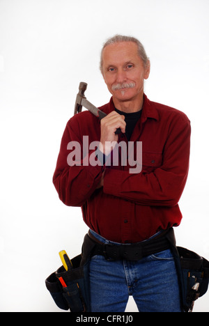 Smiling, male contractor holding a hammer, wearing tool belt Stock Photo