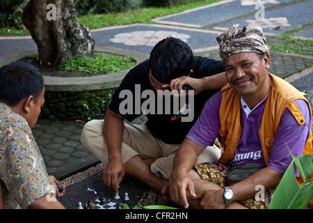 Chess players seated in th street and playing, Sulawesi, Java, Bali, South Pacific, Indonesia, Southeast Asia, Asia. Stock Photo