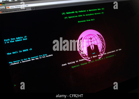 Hacked web site home page displaying message from worldwide hacker group Anonymous. Stock Photo