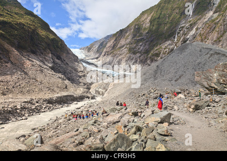 Tourists near the terminal of Franz Josef Glacier, West Coast, New Zealand Stock Photo