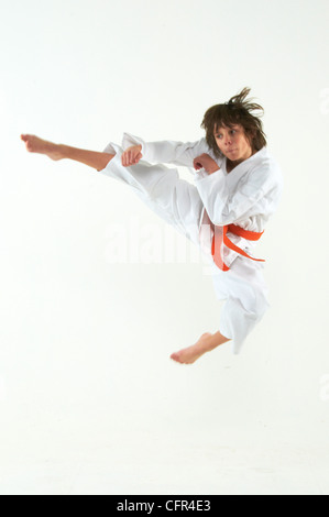 boy practicing karate on white background Stock Photo