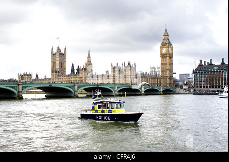 LONDON - MARCH 2012 - A metropolitan police marine support unit patrols the river Thames outside parliament Stock Photo