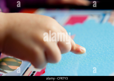 Close up child's hand using an ipad touchscreen tablet computer Stock Photo