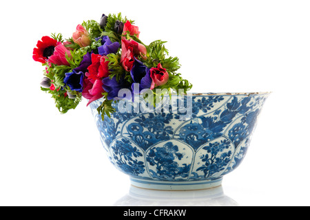 Colorful bouquet Anemones in antique Dutch bowl isolated over white Stock Photo