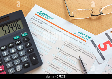 Photo of a UK self employment tax form, the deadline for the tax year is 5th April as shown by the calendar. Stock Photo