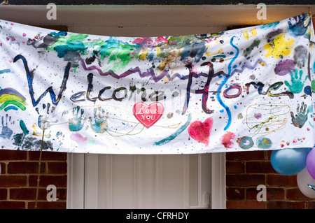 Welcome Home Banner Hanging Over A Front Door Stock Photo