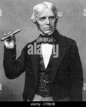MICHAEL FARADAY (1791-1867) English scientist holding a bar magnet Stock Photo