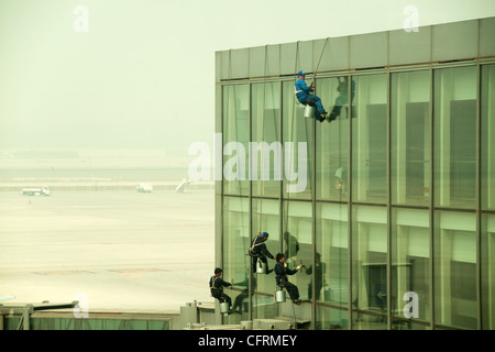 Hanging windows cleaners at Beijing Airport, China Stock Photo