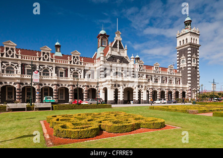 Dunedin Railway Station, now only used by the Taieri Gorge preservation railway, seen across the gardens in Anzac Square. Stock Photo