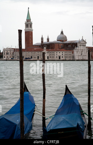 Two moored gondolas on the Tronchetto Lido di Venezia with San Giorgio Maggiore in the background, Venice Italy Stock Photo