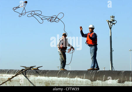 Tying down the USS Pampanito, a WW II submarine, at Bay Ship and Yacht in Alameda, Calif., Tuesday, Jan. 23, 2007, are Mike Binsfield and Ray Yuan. The submarine will be dry dock until early February when it is returned to Pier 45. (Joanna Jhanda/Contra Costa Times) Stock Photo