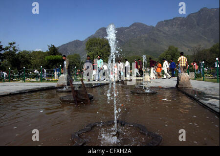 Apr 14, 2007 - Srinagar, Kashmir, INDIA - Indian Kasmiri people enjoy water fountains at the Nishat Mughal Garden overlooking the famous Dal-Lake during a holiday marking the festival of Baisakhi. Baisakhi, which is celebrated on April 14, marks the beginning of the harvest season in Northern India. Stock Photo