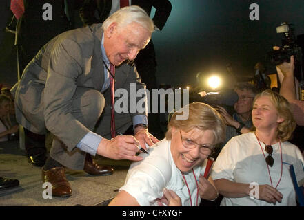 Delta Air Lines CEO Gerald Grinstein (L) signs the shirt of employee Cathy Larsen during a post-bankruptcy celebration at Atlanta Hartsfield-Jackson International Airport in Atlanta, Georgia on 30 April 2007. Delta, the nation's third largest airline, emerged from Chapter 11 bankruptcy today. Stock Photo