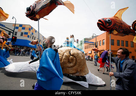 Minneapolis, MN;5/6/07;left to right: At the May Day parade, Marie Iaquinta, a chemical engineering Ph.D. student at the U of M and Meera Saffrod,4, ride aboard a snail float as they get across Lake St. on the way to Powderhorn Park. The theme of today's parade is water and its importance to sustain Stock Photo