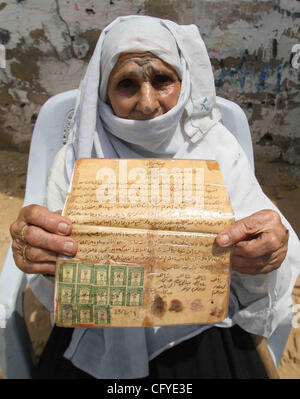 May 15, 2007 - Rafah Refugee Camp, Gaza Strip - 78 year-old Palestinian lady RASMIA AL-AKARAS presents a paper proving the ownership of her house in Wadi Hanin Village beside Beersheba in the occupied territories since 1948, on the 59th anniversary of the 'Nakba (catastrophe ) Day'. She now lives in Stock Photo